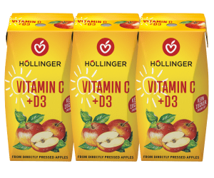 Eine gelbe Höllinger Apfelsaft-Packung mit Vitamin C + D3 auf der Äpfel und eine Sonne abgebildet sind.